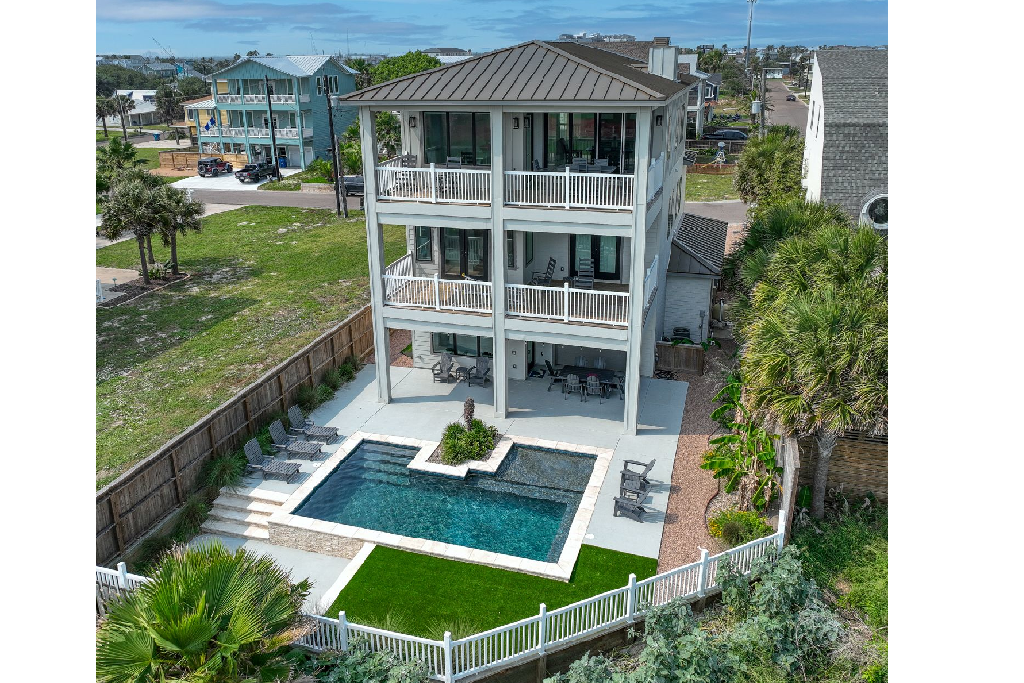 A photo of a home's back yard and pool.